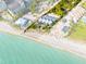 Aerial view of beachfront property with private beach access, and a modern three-unit building at 5030 N Beach Rd # 2, Englewood, FL 34223