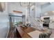 Bright dining room with a long wooden table and access to the kitchen at 5030 N Beach Rd # 2, Englewood, FL 34223