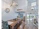 Open concept dining room with a large wooden table, and access to kitchen and living areas at 5030 N Beach Rd # 2, Englewood, FL 34223