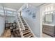 Staircase leading to upper level, with storage and a view of a bathroom at 5030 N Beach Rd # 2, Englewood, FL 34223