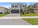 Two-story home with a two-car garage and well-maintained lawn at 32588 Tree Of Life Ave, Wesley Chapel, FL 33543