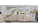Kitchen island with granite countertop and seating for four at 32588 Tree Of Life Ave, Wesley Chapel, FL 33543