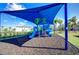 playground with shaded area and fun equipment at 32588 Tree Of Life Ave, Wesley Chapel, FL 33543