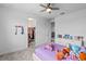 Spacious bedroom with ceiling fan, walk-in closet and loft access at 32588 Tree Of Life Ave, Wesley Chapel, FL 33543