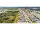 Aerial view of a residential community with lake, clubhouse, and homes at 32588 Tree Of Life Ave, Wesley Chapel, FL 33543