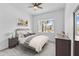 Serene bedroom with large window, dresser and nightstand at 32588 Tree Of Life Ave, Wesley Chapel, FL 33543