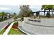 Gated community entrance with a water feature and landscaping at 32588 Tree Of Life Ave, Wesley Chapel, FL 33543