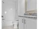 Bathroom features a shower/tub combo, granite countertop, and white cabinets at 32588 Tree Of Life Ave, Wesley Chapel, FL 33543