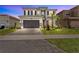 Two-story home with two-car garage and landscaping at 32588 Tree Of Life Ave, Wesley Chapel, FL 33543
