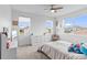 Bright bedroom with large windows, ceiling fan, and ample closet space at 32588 Tree Of Life Ave, Wesley Chapel, FL 33543