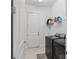 Convenient laundry room with washer, dryer, and shelving at 32588 Tree Of Life Ave, Wesley Chapel, FL 33543