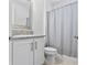 Clean bathroom with granite countertop, white cabinets, and shower/tub combo at 32588 Tree Of Life Ave, Wesley Chapel, FL 33543