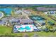 Aerial view of community with pool, tennis, and homes at 32588 Tree Of Life Ave, Wesley Chapel, FL 33543