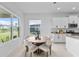 Bright kitchen nook with a round table and view of backyard at 32588 Tree Of Life Ave, Wesley Chapel, FL 33543