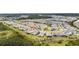 Wide aerial view of a residential neighborhood with a lake at 32588 Tree Of Life Ave, Wesley Chapel, FL 33543