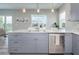 Modern kitchen with an island, gray cabinets, and stainless steel appliances at 3431 Sheephead Dr, Hernando Beach, FL 34607