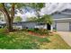 Well-maintained exterior with lush landscaping and attached garage at 20 Summerwinds Ln, Oldsmar, FL 34677