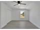 Spacious bedroom with double doors, ceiling fan, and window view at 5224 Mango Fruit St, Seffner, FL 33584