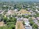 Aerial view of a neighborhood with houses and a large open field at 5224 Mango Fruit St, Seffner, FL 33584