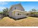 Rear view of house with sunroom and fenced yard at 5224 Mango Fruit St, Seffner, FL 33584