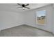 Well lit bedroom with wood-look floors and a window with a view at 5224 Mango Fruit St, Seffner, FL 33584