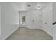 Bright entryway with gray wood-look flooring and white doors at 5224 Mango Fruit St, Seffner, FL 33584