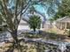 Two-story house with a gray exterior, a two-car garage, and a large tree in the front yard at 5224 Mango Fruit St, Seffner, FL 33584