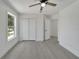 Spacious bedroom with wood-look floors, double doors, and a view at 5224 Mango Fruit St, Seffner, FL 33584