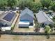 Rear view of a house with a sunroom addition and solar panels at 5224 Mango Fruit St, Seffner, FL 33584