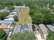 Aerial view of residential homes and a large open green space at 5224 Mango Fruit St, Seffner, FL 33584