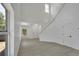 Open concept living area with high ceilings and gray flooring at 5224 Mango Fruit St, Seffner, FL 33584