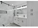 Modern bathroom with double vanity, large shower, and white cabinets at 5224 Mango Fruit St, Seffner, FL 33584