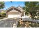 Two-story home with gray exterior, attached garage, and landscaped yard at 5224 Mango Fruit St, Seffner, FL 33584