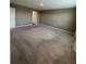 Spacious bedroom featuring neutral paint, carpet flooring, and an adjoining bathroom entrance at 462 Spotted Slipper Pl, Ruskin, FL 33570