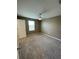 Cozy bedroom with neutral walls, carpet flooring, ceiling fan, and a window for ample natural light at 462 Spotted Slipper Pl, Ruskin, FL 33570