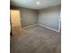 Bedroom featuring neutral carpet and walls, a closet and an ensuite bathroom at 462 Spotted Slipper Pl, Ruskin, FL 33570