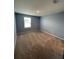 Calm bedroom with neutral carpet and paint, featuring a window providing natural light at 462 Spotted Slipper Pl, Ruskin, FL 33570