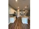 Bright kitchen featuring white cabinets, granite countertops, stainless steel appliances, and an island with a sink at 462 Spotted Slipper Pl, Ruskin, FL 33570