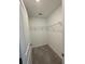 Cozy walk-in closet with carpeted flooring and organized wire shelving for efficient storage at 462 Spotted Slipper Pl, Ruskin, FL 33570