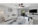 Living room features a sofa, sliding door to patio, and mounted TV at 1028 Apollo Beach Blvd # 27, Apollo Beach, FL 33572