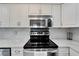 Modern kitchen with stainless steel appliances and white cabinets at 1028 Apollo Beach Blvd # 27, Apollo Beach, FL 33572
