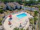Top-down view of refreshing community pool with patio furniture at 1028 Apollo Beach Blvd # 27, Apollo Beach, FL 33572