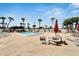 Community pool with lounge chairs and picnic tables at 1028 Apollo Beach Blvd # 27, Apollo Beach, FL 33572
