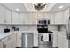 Modern kitchen featuring white cabinets and stainless steel appliances at 1028 Apollo Beach Blvd # 27, Apollo Beach, FL 33572