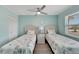 Guest bedroom with twin beds and light blue walls at 1028 Apollo Beach Blvd # 27, Apollo Beach, FL 33572