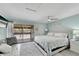 Main bedroom with king-size bed and access to a private balcony overlooking the pool at 1028 Apollo Beach Blvd # 27, Apollo Beach, FL 33572