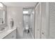 Grey bathroom with white vanity, toilet, and shower at 1028 Apollo Beach Blvd # 27, Apollo Beach, FL 33572