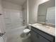Bathroom with single vanity, granite countertop, and tub at 36188 Welsh Glade Rd, Dade City, FL 33525