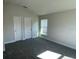 Spacious bedroom with gray carpeting and double closets at 36188 Welsh Glade Rd, Dade City, FL 33525