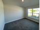 Bright bedroom with large window and grey carpeting at 36188 Welsh Glade Rd, Dade City, FL 33525